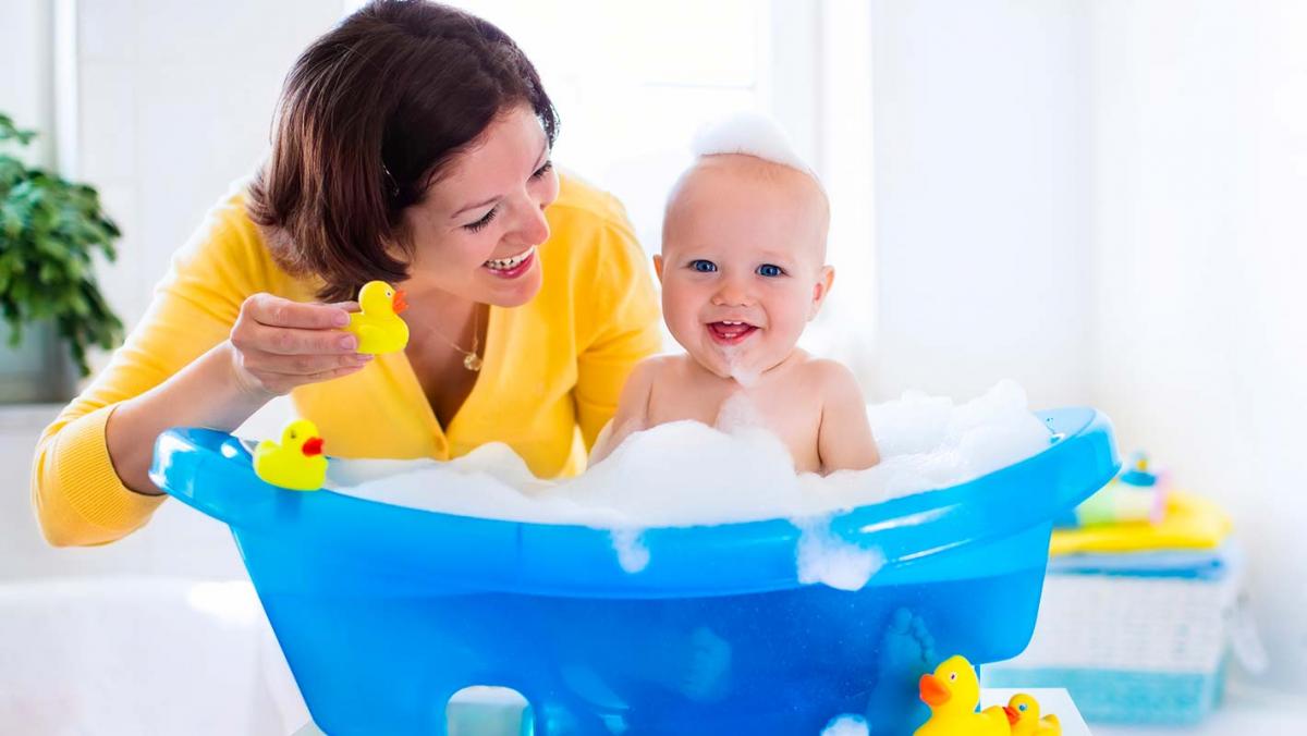 Mother gives her baby a bath